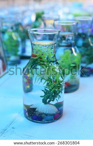 Bright and beautiful colors of plastic flowers and plants in water jugs with soothing blue light setting