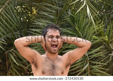 Man with hair on chest shouting in excitement