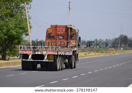 Editorial: Gurgaon, Haryana, India on 31st March 2014, Big truck on well laid tarmac road