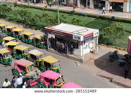 Editorial,06th June 2015:Gurgaon,Delhi,India:Auto or auto rickshaw drivers in queue at Prepaid booths,these booths are equipped with CCTV to capture photos of passengers and drivers for safety purpose
