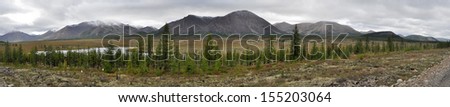Russia, Yakutia, Oymyakon highlands, a ridge of Suntar-khayata. Panorama of a mountain ridge near highway \