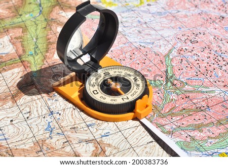 Compass and  maps. Compass on the map - this is the open door to the country adventure.