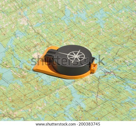 Compass lies on a topographic map. Compass on the map - this is the open door to the country adventure.