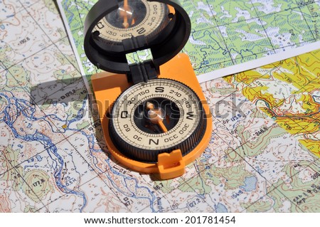 Maps and compass. Compass on the map - this is the open door to the country adventure.