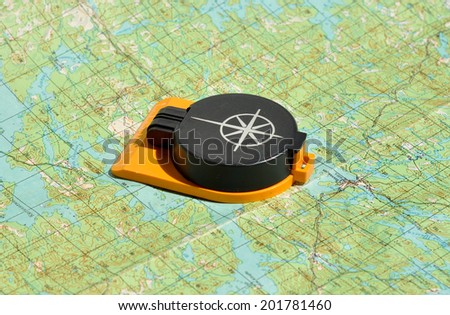 Compass lies on a topographic map. Compass on the map - this is the open door to the country adventure.
