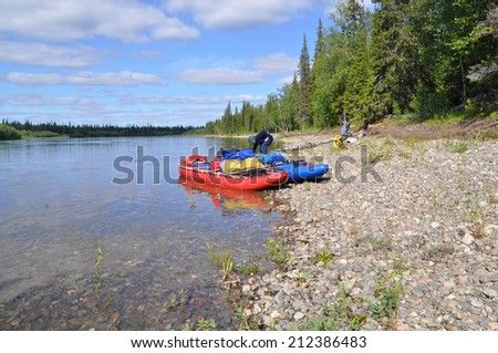 River landscape with kayaks. The polar Urals, the river Lemva, Republic of Komi, Russia.