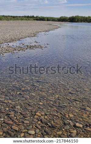Summer river landscape of the Polar Urals. Valley North of the river are lined with pebbles.