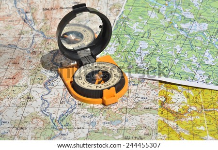 Maps and compass. Compass on the map - this is the open door to the country adventure.