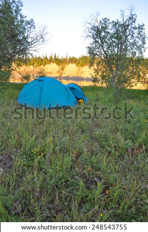 Polar Ural, Komi Republic, the beaches along the banks of the river. Camping tent on the banks of the river.