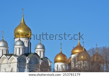 Golden domes of Orthodox churches of the Moscow Kremlin. Gilded dome on the background of blue sky.