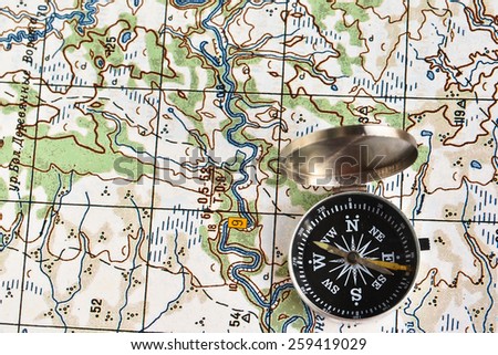 The magnetic compass and topographic map. Travel compass and map symbols adventures.