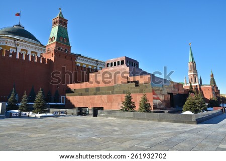 Red square, the Moscow Kremlin and the Lenin mausoleum. The bright sun lights the Kremlin towers, the wall and the mausoleum.