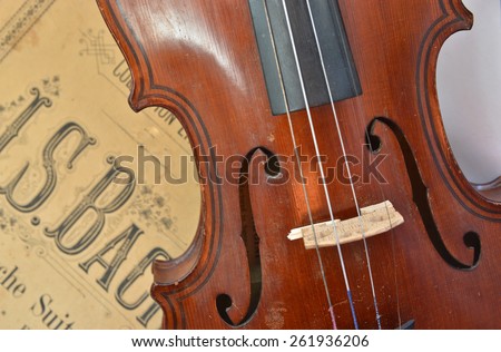 German ancient violin and notes. Old violin, copy of Majini made Saxony, in the 19th century.