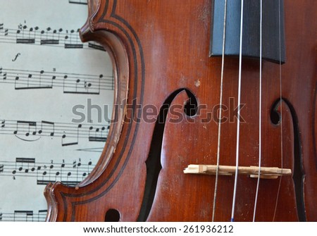 German ancient violin and notes. Old violin, copy of Majini made Saxony, in the 19th century.