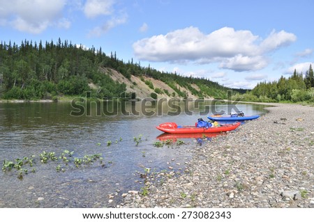Inflatable kayaks on the shore taiga rivers. The river of the polar Urals in the Republic of Komi, Russia.