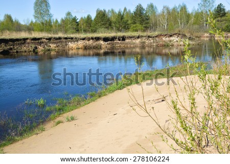 The beginning of may on a protected river. Spring landscape, the river and the first greens in the trees.