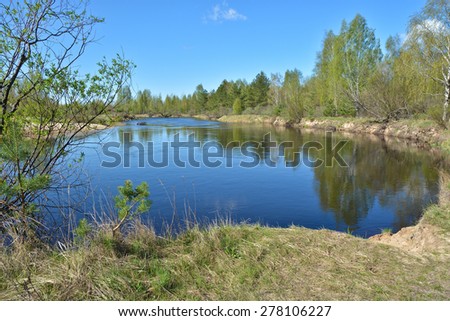 The beginning of may on a protected river. Spring landscape, the river and the first greens in the trees.