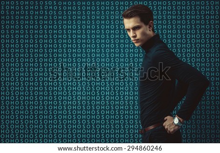 Man model in strict black dress on glass background with letters. Facial profile. Fashion style