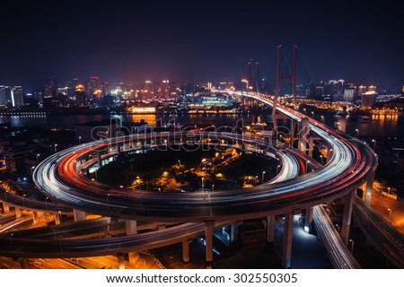 Modern city traffic road at night. Transport road junction on the bridge.