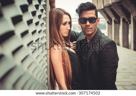 Young and trendy man and woman models walks of the modern street. Fashion Style