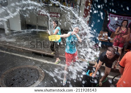 BANGKOK - APRIL 13: Unidentified revellers take part in a water fight event on Khao San Road during celebrations of Songkran, or the Thai New Year, on April 13, 2014 in Bangkok, Thailand.