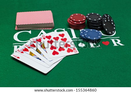 hand of cards and casino chips for poker