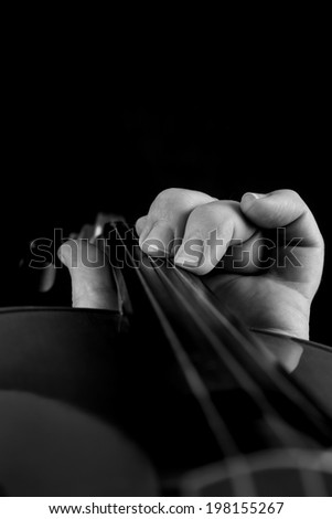 black and white close up of hand playing violin
