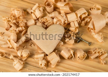 Wood heart on table with wood shavings