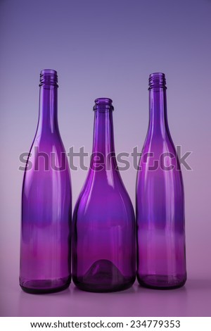 Purple glass bottle with blue green back lighting
