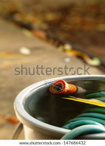 small gray water bucket filled full of water