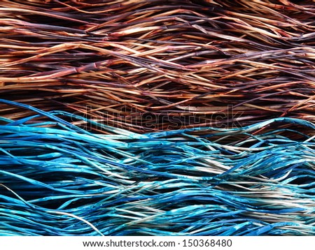 stock of dried dyed sedge fiber prepared as raw material for natural mat carpet weaving, colorful traditional handmade handicraft from Thailand