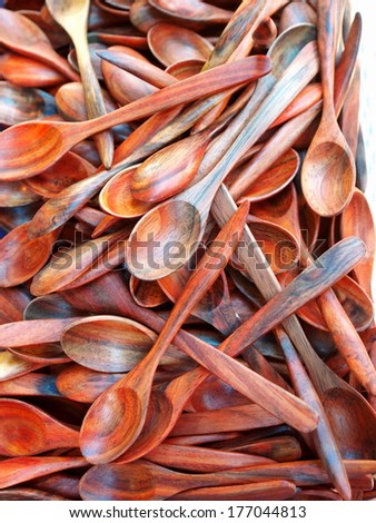 wooden spoon small teaspoons new unused made of brown hard wood for sale on a street market in Thailand