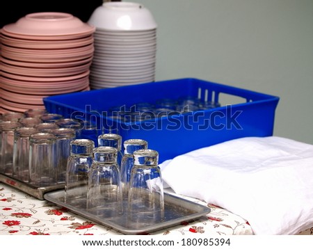 glasses and tableware on a table with home country style decorative tablecloth prepare for a dinner party