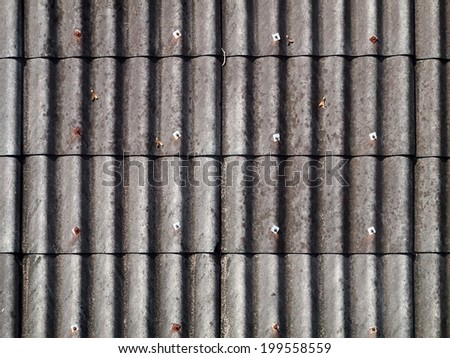 old weathered dirty gray asbestos roof panel picture taken from above