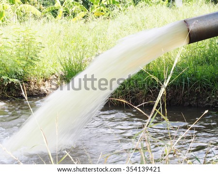 powerful water flowing from a large pipe pump using diesel machine modified convert to be water pump supply for agricultural universal use in fish and shrimp farm in country Thailand
