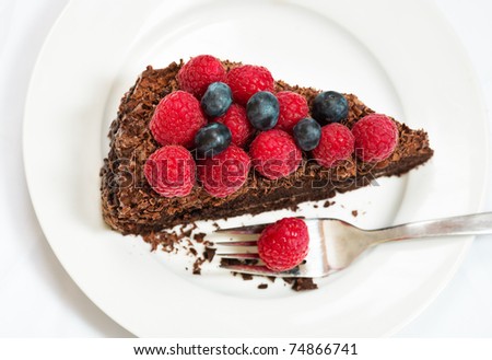 Slice of chocolate cake with berries - view from above