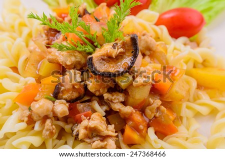 Pasta with meat, tomato sauce and vegetables on white background.