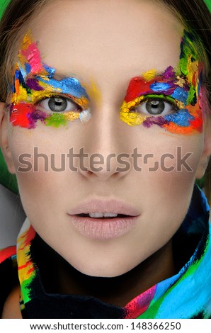Close up of a face of a girl with creative visage. Face art.