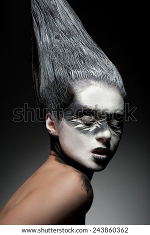 Beautiful  fashion face with black and white artistic ethnic makeup on her face