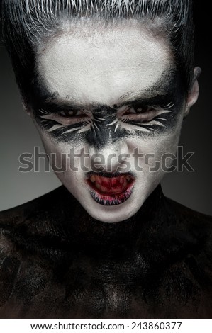 Beautiful  fashion face with black and white artistic ethnic makeup on her face