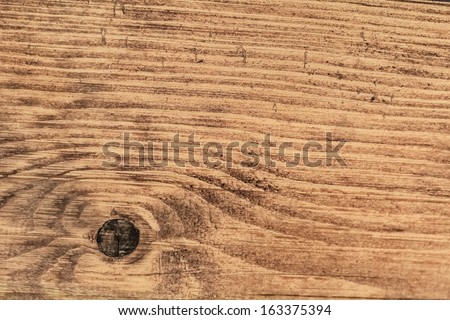 Old, rough textured, weathered, cracked White Pine plank surface, with wood knot - detail.