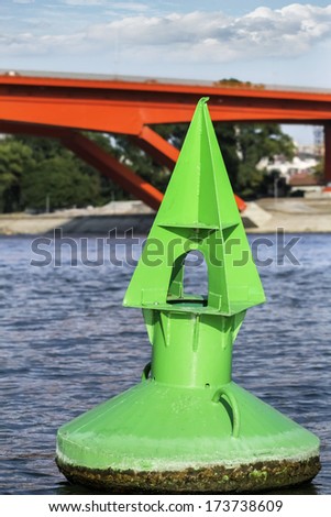 Green metal navigation nautical buoy, anchored at the downstream approach to the Gazelle bridge, on Sava river - Belgrade - Serbia.