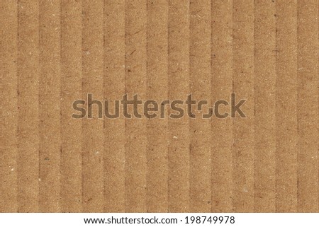 Photograph of recycle brown corrugated, coarse grain, striped cardboard, grunge texture sample