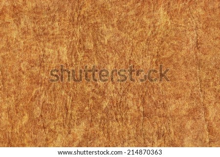 Photograph of old, weathered, rough, creased, coarse grained, exfoliated Yellow-ocher leather, grunge texture sample.
