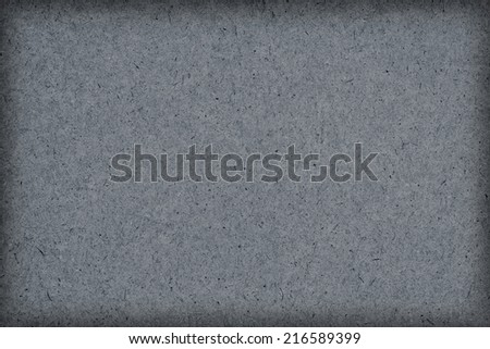 Photograph of Gray recycle paper, extra coarse grain, vignette grunge texture sample.