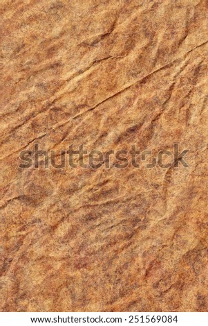 Photograph of old Recycle Kraft Brown Paper, coarse grain, crushed crumpled, mottled, grunge texture sample.