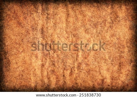 Photograph of old Recycle Kraft Brown Paper, coarse grain, crushed crumpled, mottled, vignette grunge texture sample.