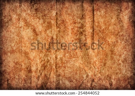 Photograph of old Recycle Kraft Brown Paper, coarse grain, crushed crumpled, stained, mottled, vignette grunge texture sample.