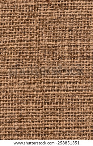 Photograph of raw, roughly woven, coarse grain, burlap grunge texture.