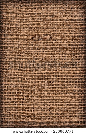 Photograph of raw, roughly woven, extra coarse grain, burlap vignette grunge texture.